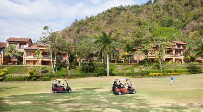 two red golf carts on golf course