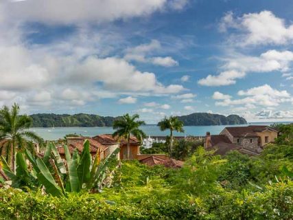 Pacific ocean and island behind the roof tops of Villa Malibu