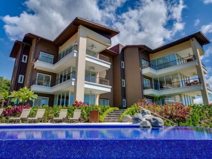 Three story building with pool in front