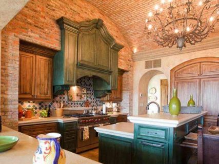 gourmet kitchen with brick walls